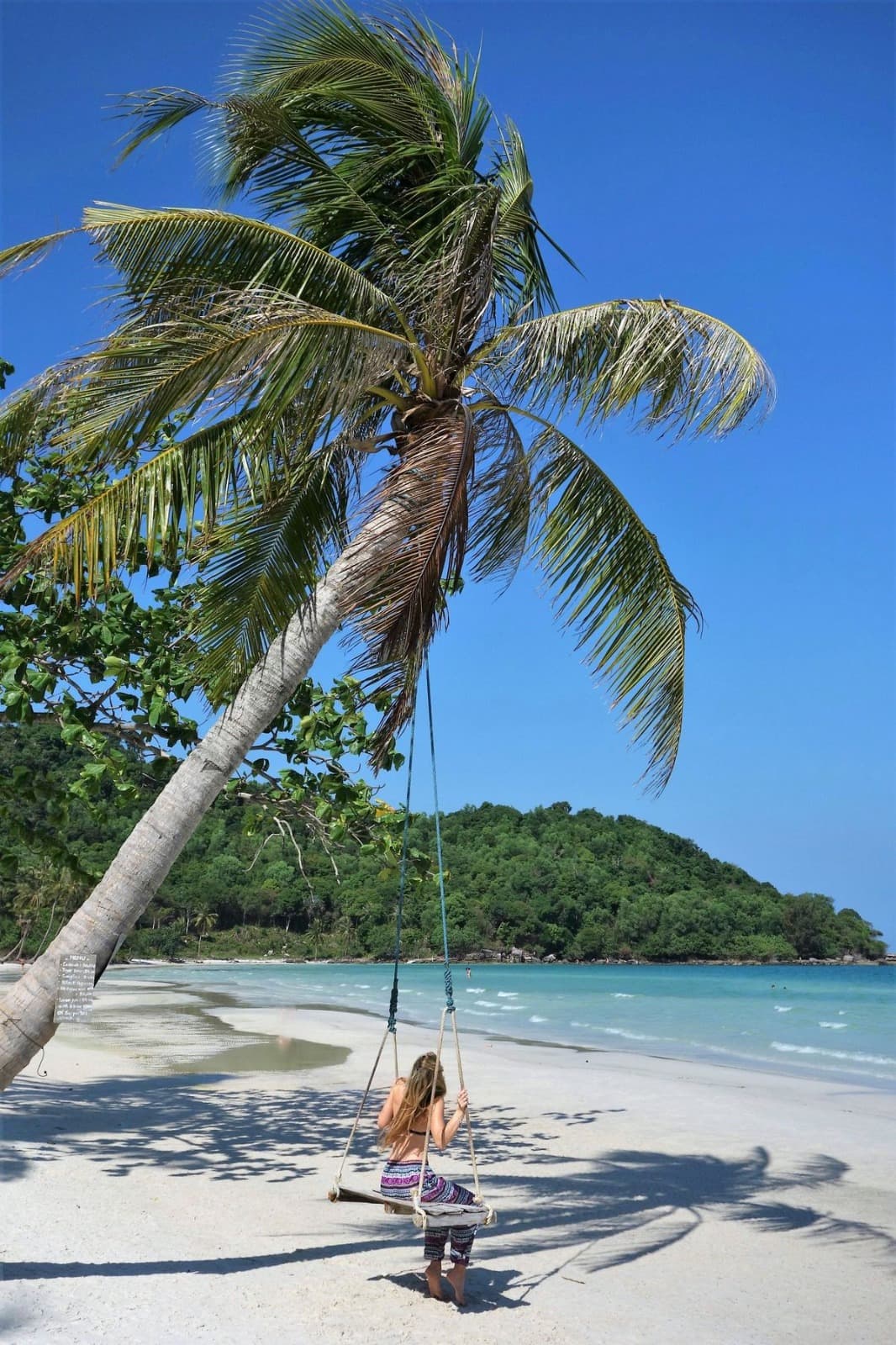 Traveller enjoying a tropical beach swing